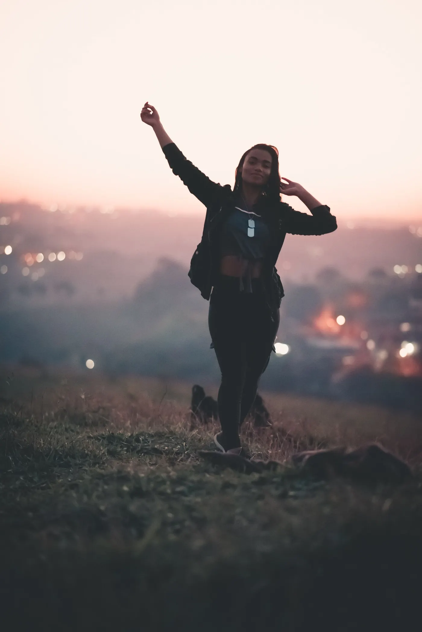 Woman walking on a hillside at sunset